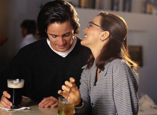 Couple talking at bar.