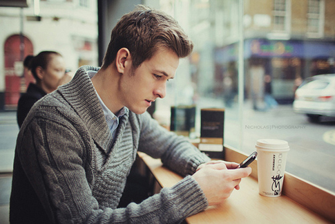 Good looking guy texting on his phone.